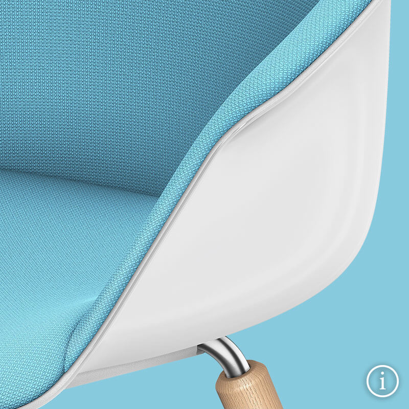 A front view close-up of the SHUFFLEis1 lounge chair with a white plastic shell, fully upholstered in blue and a part of the wooden leg on a blue background. Further information is available via the information button at the bottom right | by Interstuhl