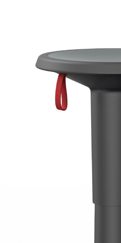Close-up of the UP stool in black, the height of which can be adjusted with the red carrying strap.